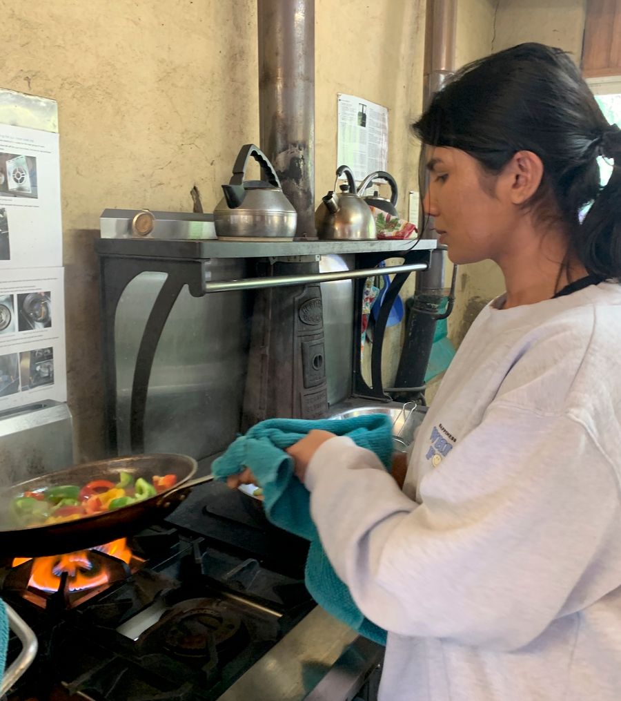 (Dilini cooking at a Hope Co-Op community weekend)