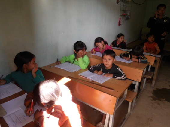 The children study in a dim room
