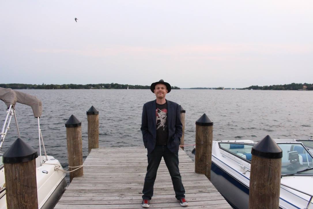 Band leader Adam on a pier with Lake Minnetonka (Minnesota) in the background